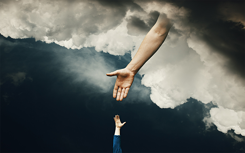 Hand reaches down from the clouds to a child's hand.