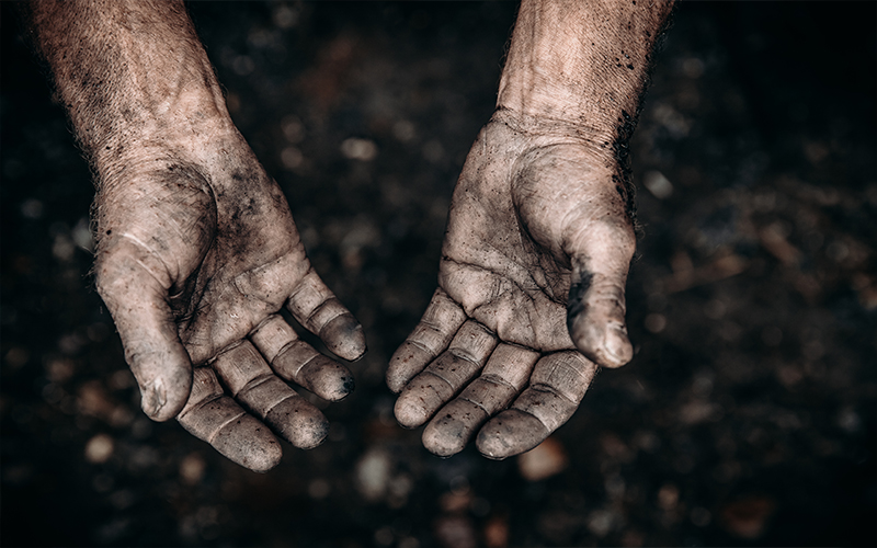 Tough hands covered in dirt